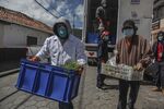 Azuay Prefecture workers deliver baskets with food in Cuenca, Ecuador, on April 30.