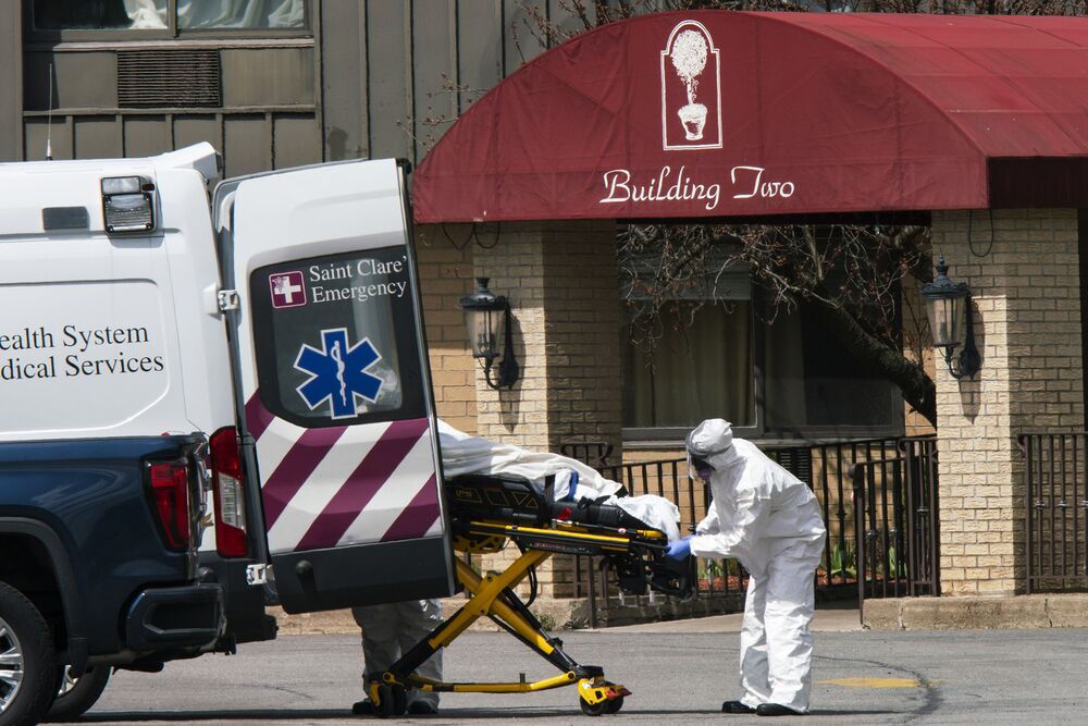 Medical professionals load a deceased body into an ambulance at the Andover Subacute and Rehabilitation Center in Andover, New Jersey, on April 16.