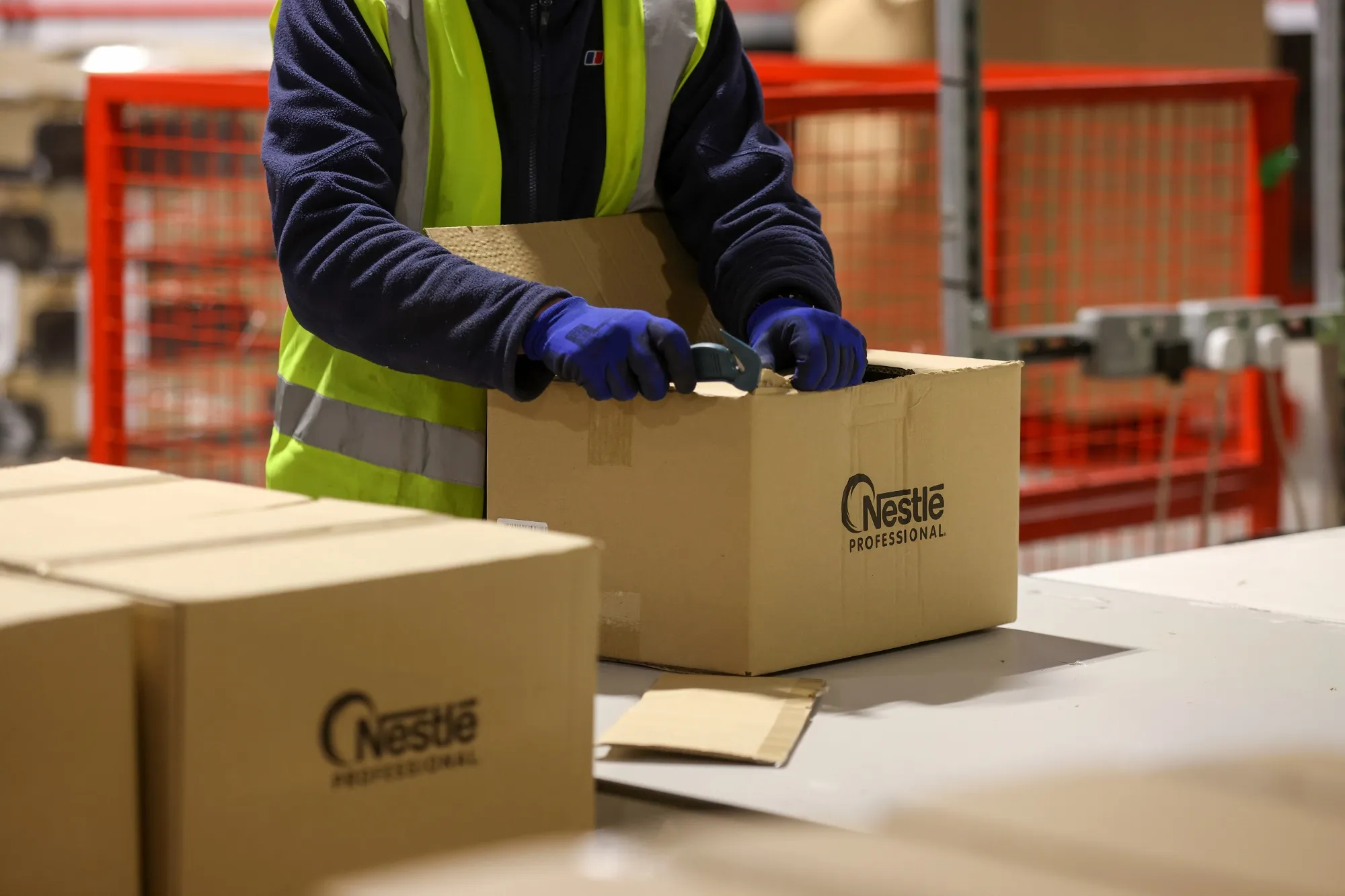 An employee packs products manufactured by Nestle SA.