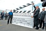 Jimmy Lifton, left, with Gary Burtka closes the clapboard slate signifying that the studio is a done deal on August 27, 2009 in Allen Park, Mich.