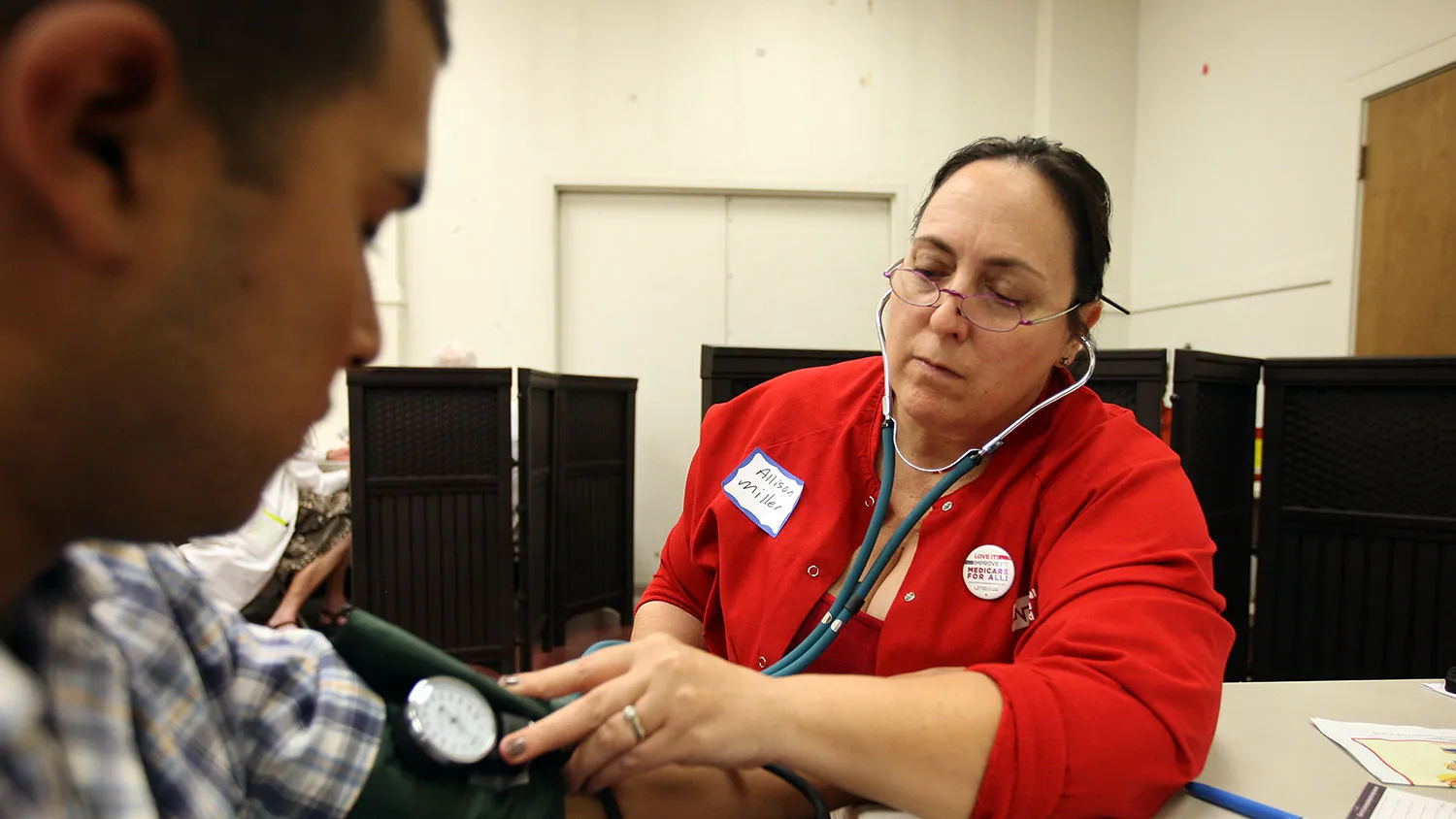 Nurse Allison Miller checks the blood pressure of Oscar Ramirez as nurses and physicians give free basic health screenings and call attention to what they say is the ongoing healthcare emergency despite the decision of the U.S. Supreme Court to uphold the Affordable Care Act, on July 10, 2012 in Los Angeles, California.
