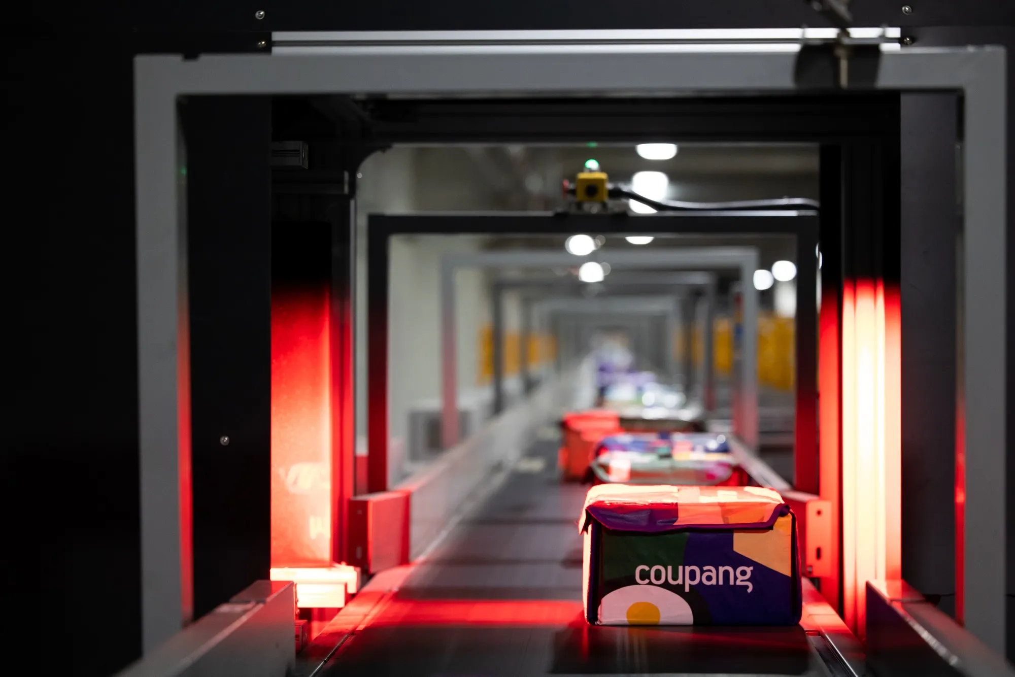 Eco-bags carrying fresh food are laser scanned at a Coupang fulfillment center in Bucheon, South Korea, on Feb. 19.