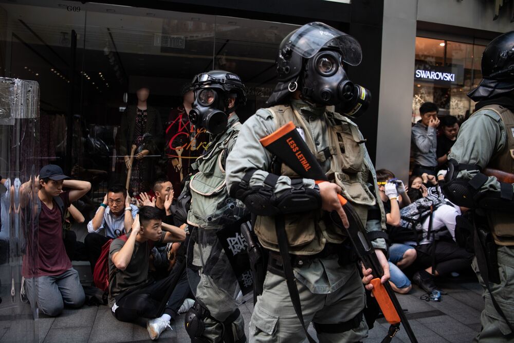 People are detained by riot police during a protest in the Central district of Hong Kong, on Nov. 13.