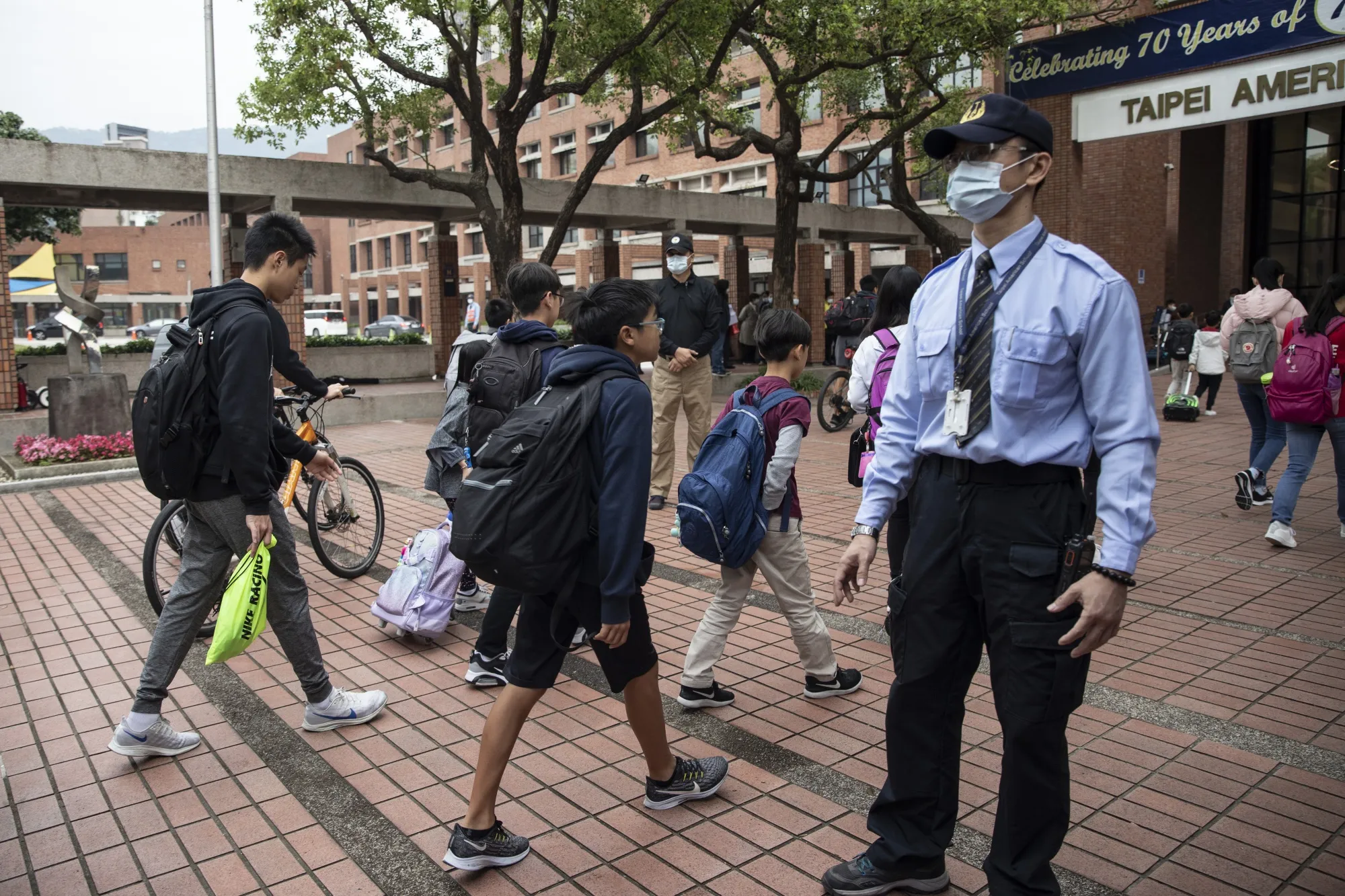 Students enter the Taipei American school in Taipei on March 18.