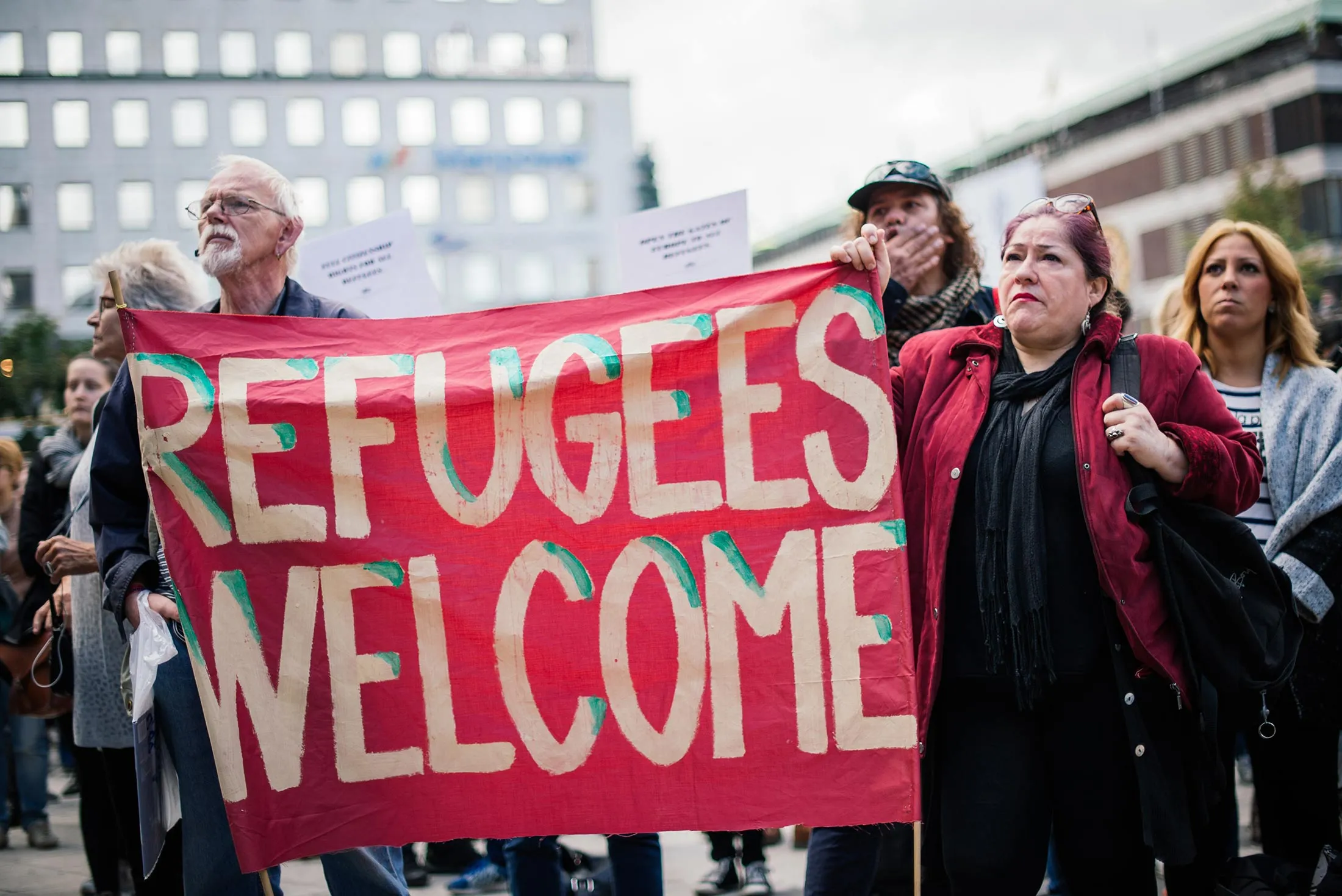 Demonstrators hold a banner in solidarity with refugees in Stockholm on Sept. 12.
