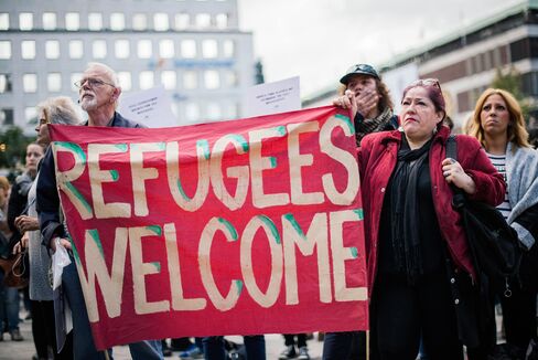 Demonstrators hold a banner in solidarity with refugees in Stockholm on Sept. 12.