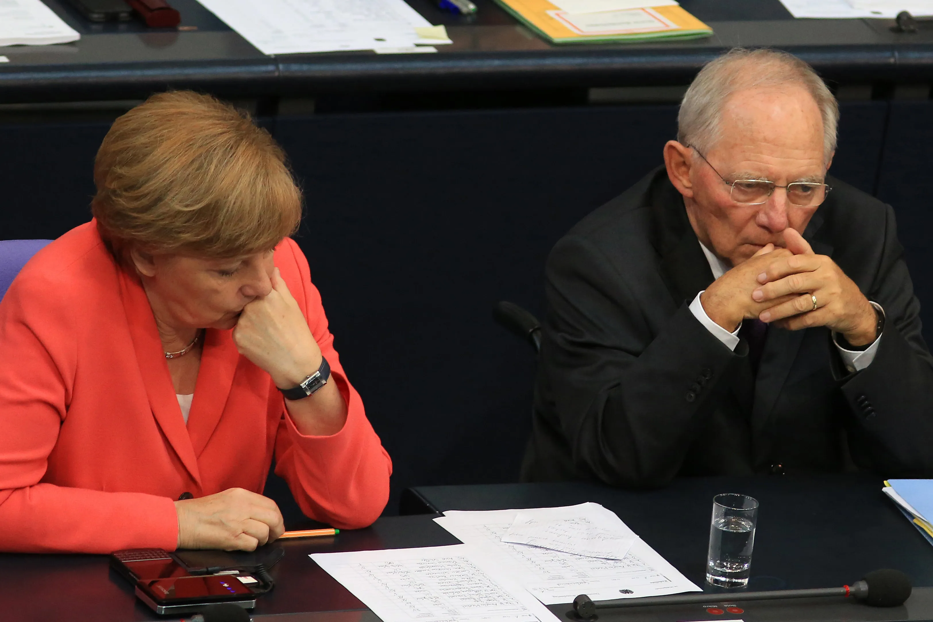 Angela Merkel, Germany's chancellor, sits beside Wolfgang Schaeuble, Germany's finance minister. Photographer: Krisztian Bocsi/Bloomberg
