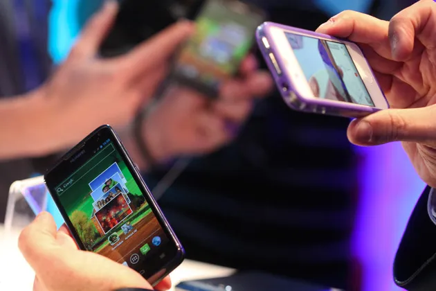 A visitor photographs the side profile of a Huawei Technologies Ascend D quad mobile phone at a launch event prior to the Mobile World Congress exhibition in Barcelona, Spain.