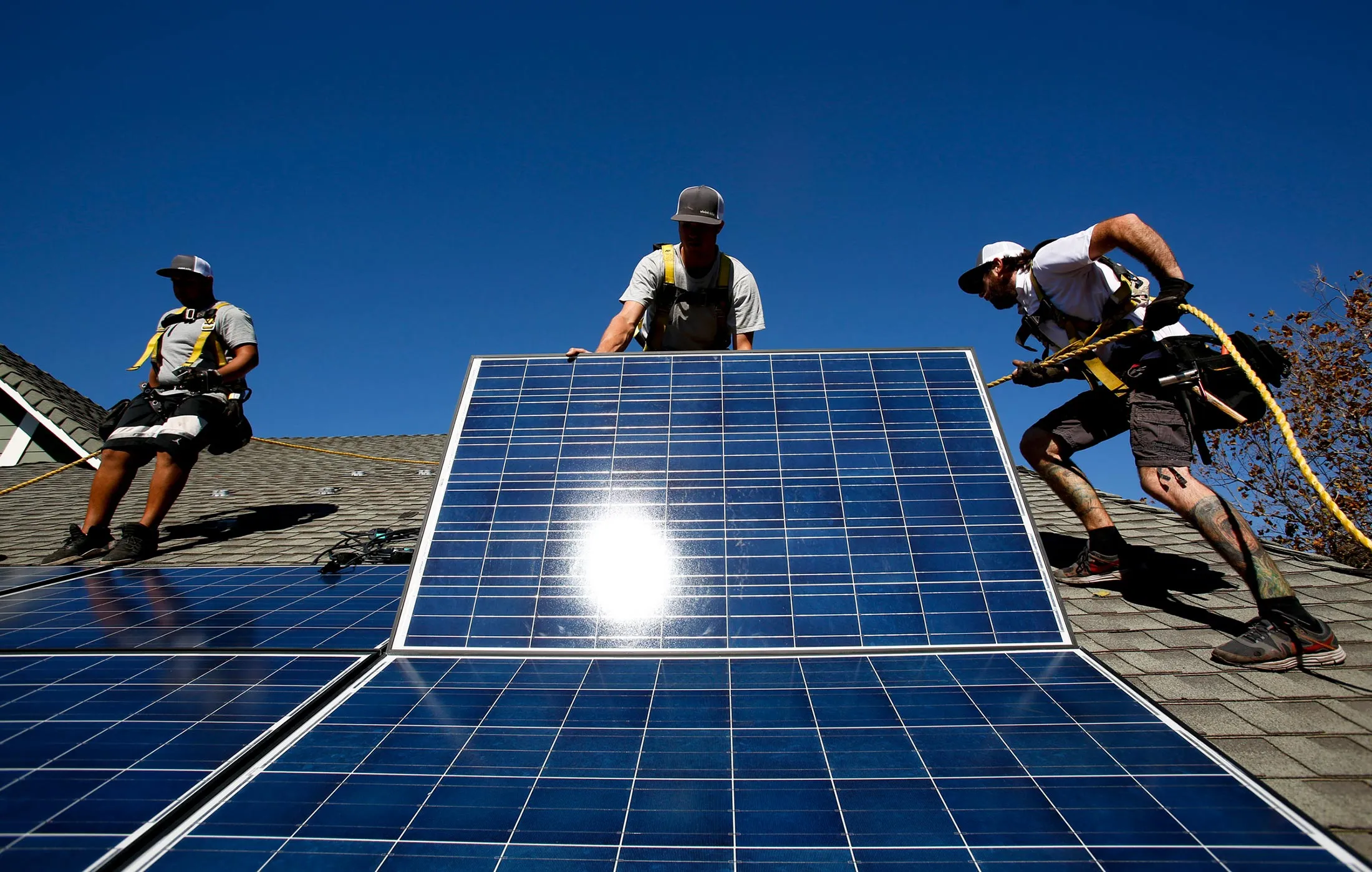 Workers from Vivint Solar Inc. install solar panels on the roof of a home in Camarillo, Calif. on Nov. 4, 2013.
