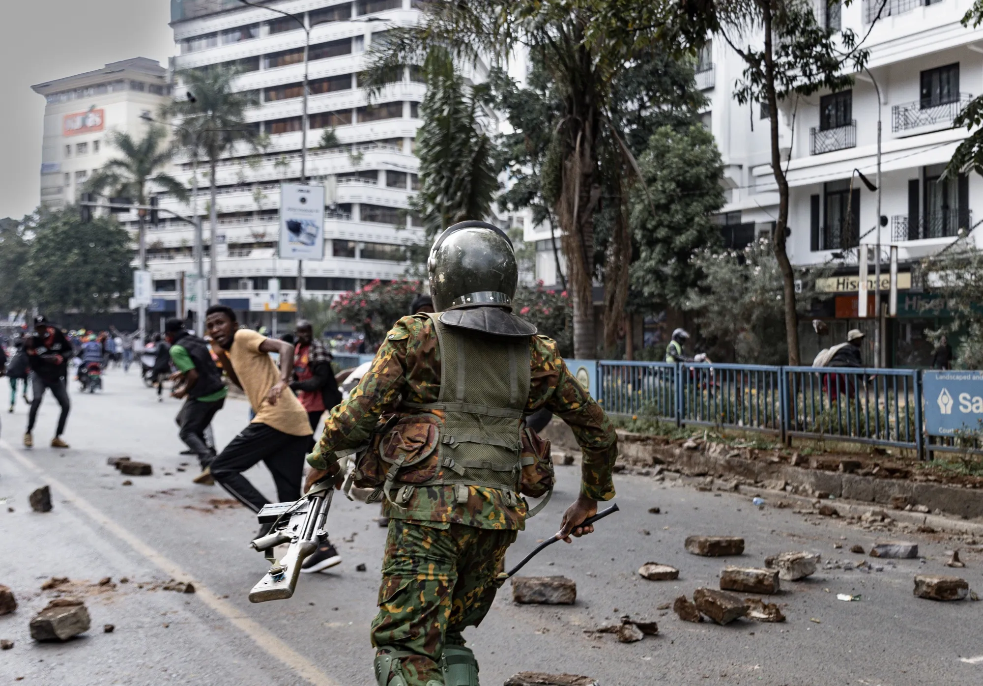 Protesters run from the police during a demonstration in Nairobi, on June 25.