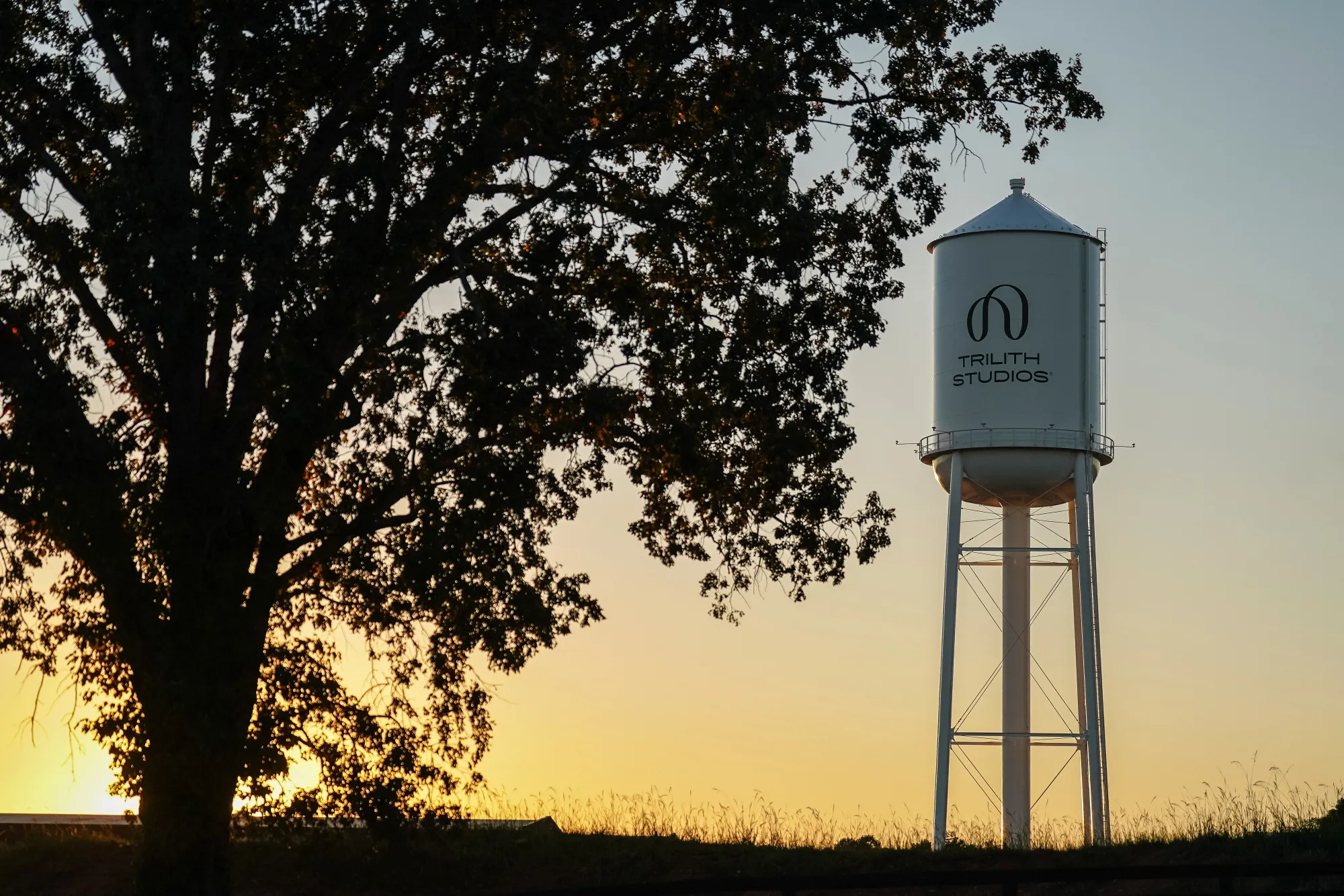A water tower emblazoned with the Trilith logo.