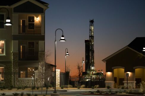 An new oil well is drilled near new apartments in Midland, Texas.