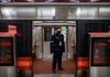 A Chinese security guard wears a protective mask as he stands in a nearly empty subway car during rush hour on February 14, 2020 in Beijing, China.
