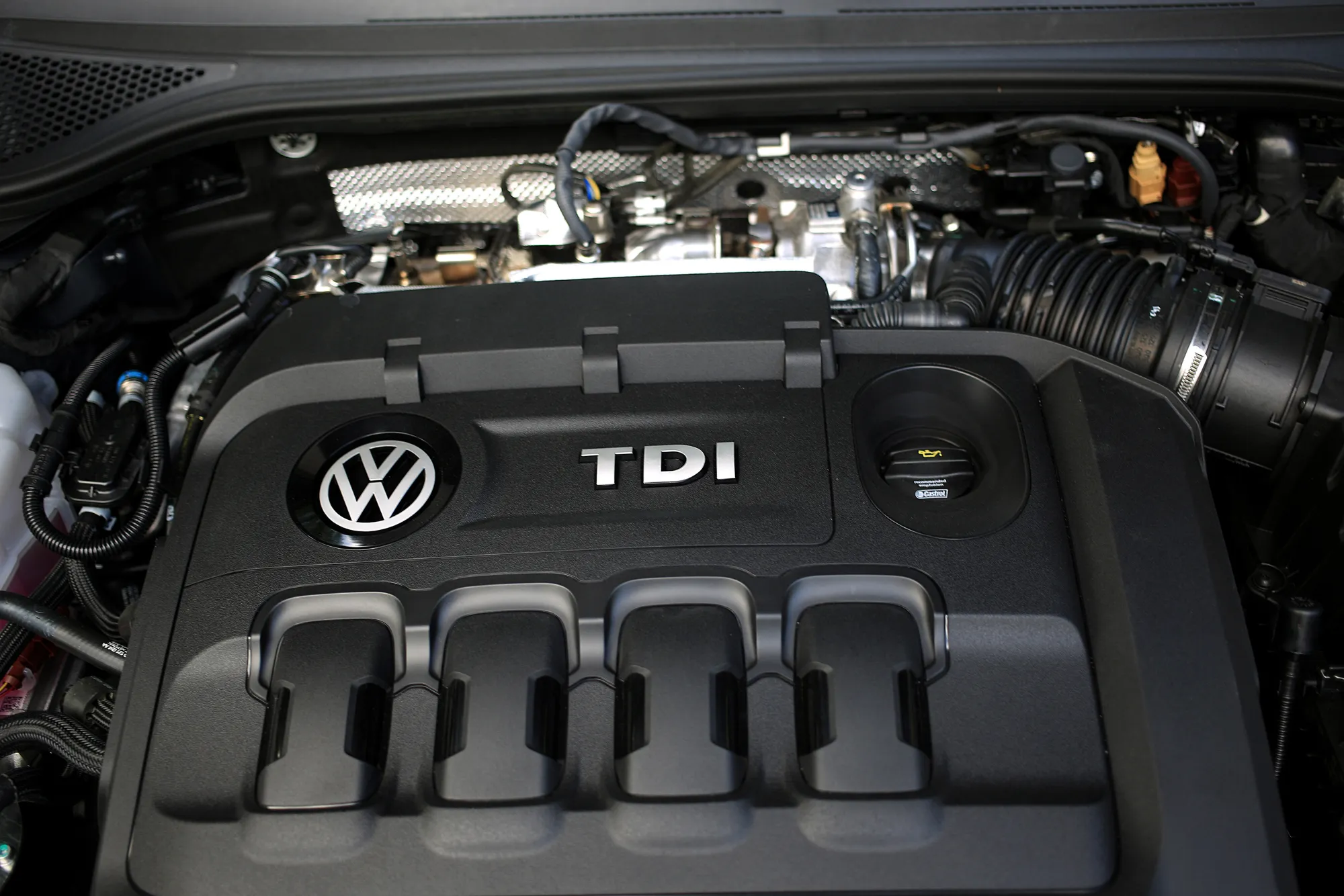A TDI diesel engine sits under the hood of a Volkswagen automobile in Hannover, Germany.