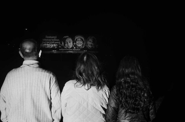 Family members of Nicholas Cruz Burris look at a billboard in Kansas that says: Fentanyl killed our holidays, don't let it kill yours!