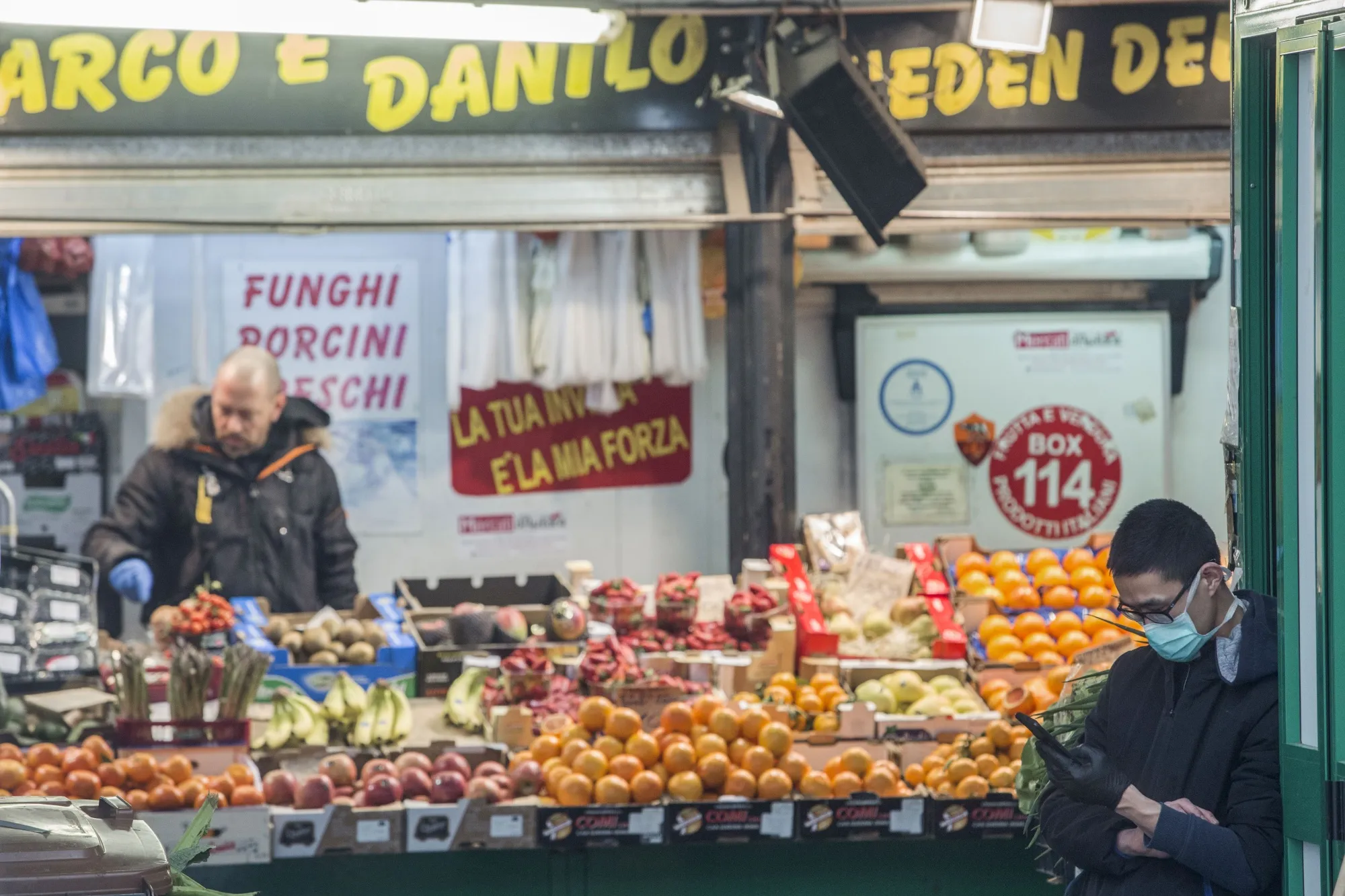 A market trader, wearing a protective face mask, waits for customers at Piazza Vittorio market in Rome, on March 5.