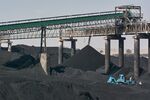 A conveyor bridge over piles of coal at an open-cast coal mine in&nbsp;South Africa.