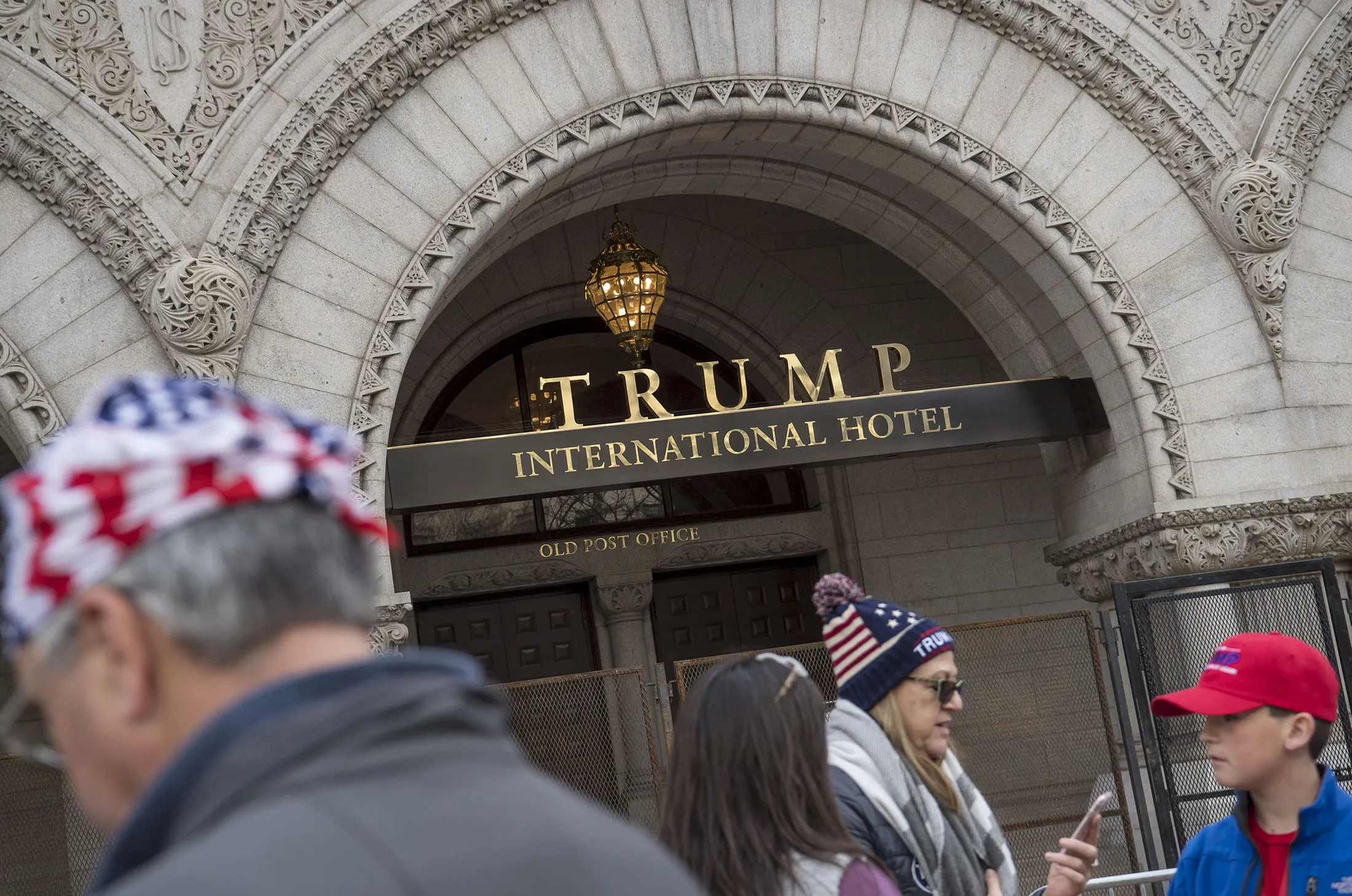 Visitors stand outside of Trump International Hotel in Washington, D.C.
