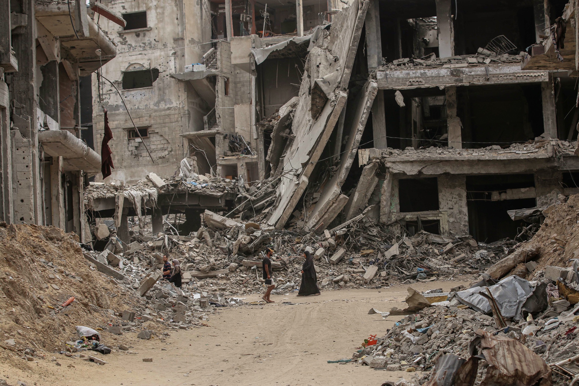 A photo of a man and a woman in Khan Younis in Southern Gaza surrounded by destroyed buildings.