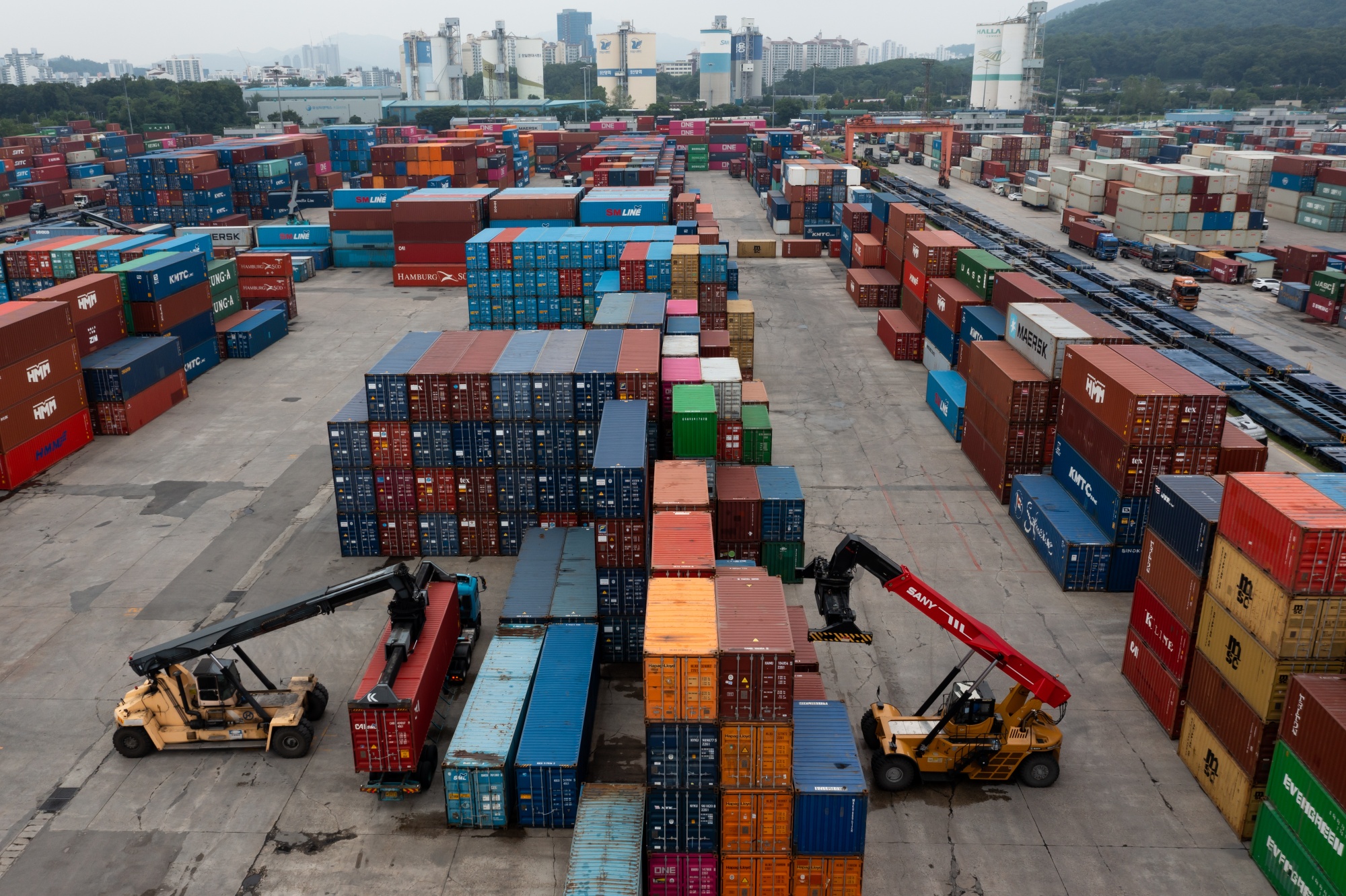 Reach stackers transport containers at the Uiwang Inland Container Depot in Uiwang, South Korea, on Monday, May 31, 2021. South Korea’s exports surged the most since 1988 in May as a reopening of overseas economies boosted demand for products manufactured by the Asian nation.