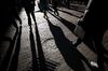 Pedestrians walk along Wall Street near the New York Stock Exchange (NYSE) in New York, U.S.