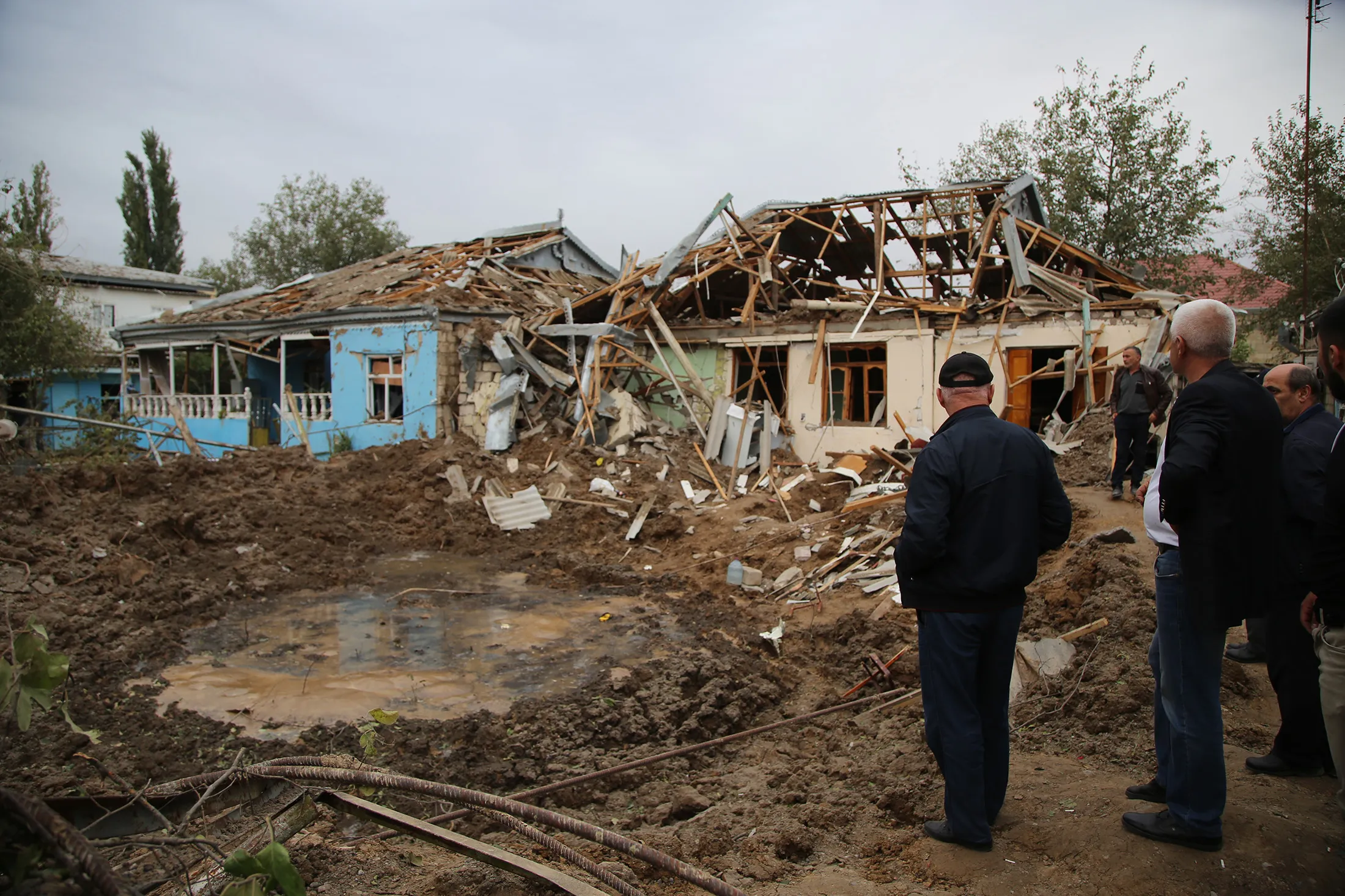 Residents inspect the house damaged after rocket attack carried out allegedly by the Armenian army in Beylagan district, Azerbaijan on Oct.&nbsp;04.