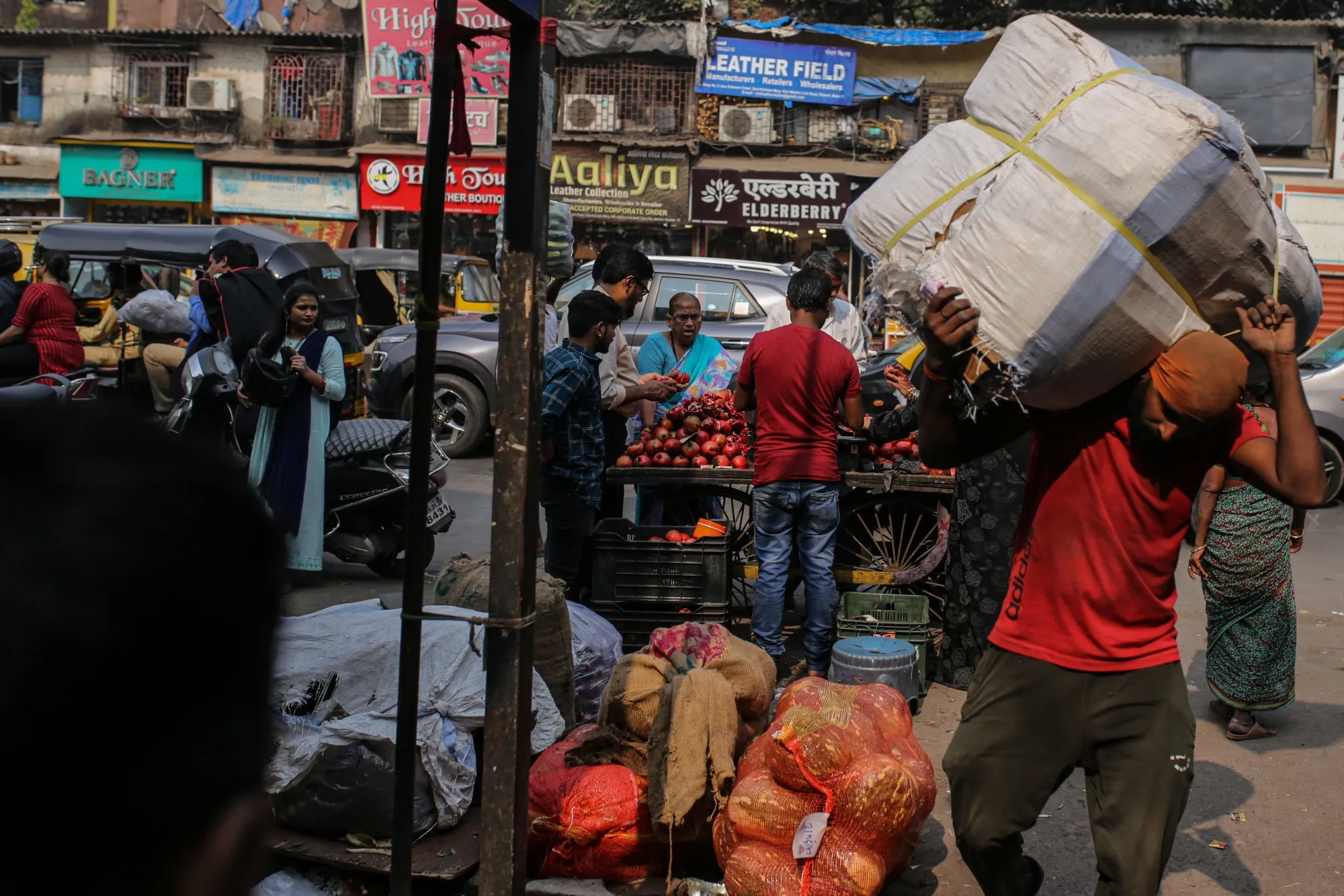 A worker carries goods in the Dharavi district in Mumbai.