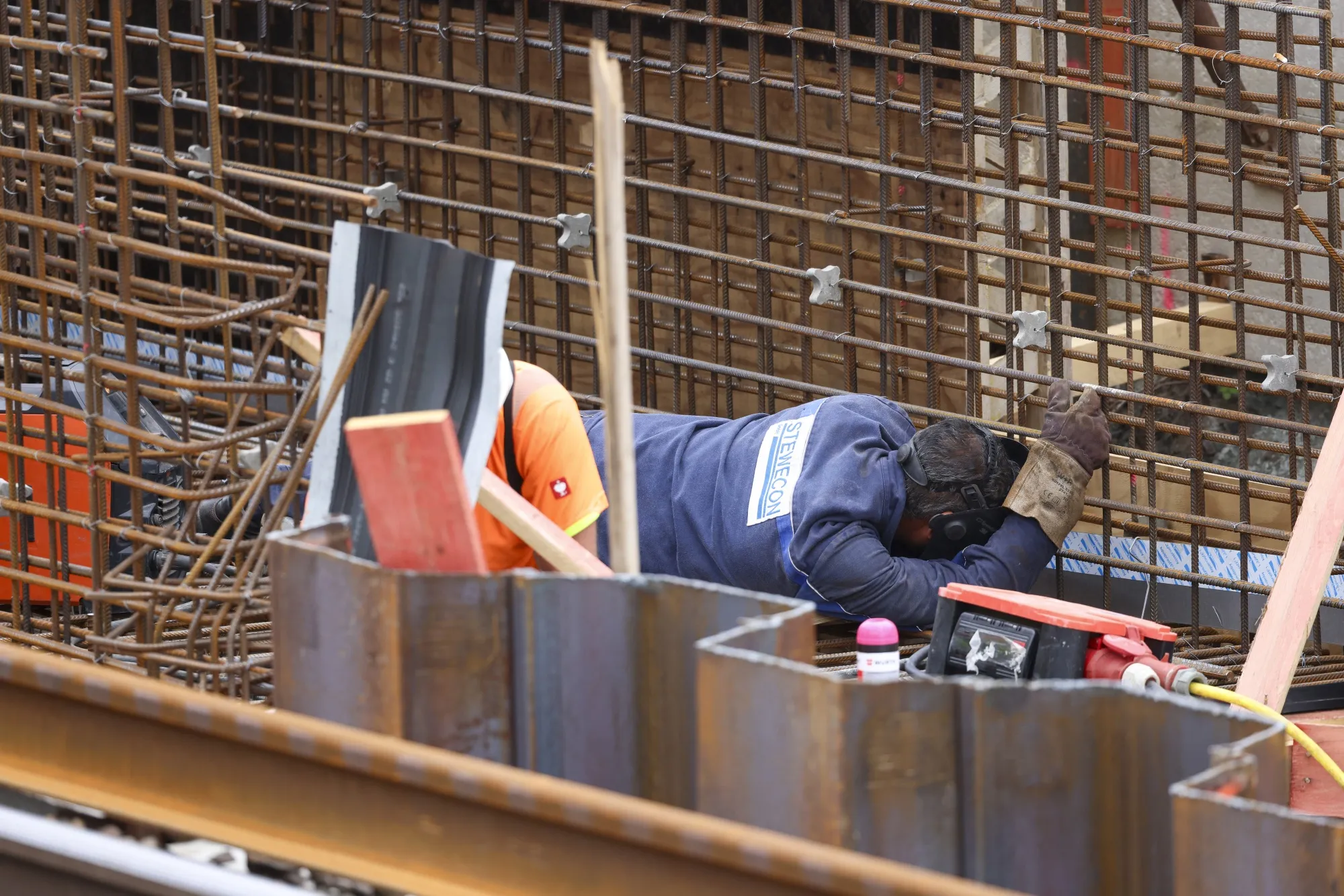 A worker welds steel near a new station entrance at the refurbishment work site of Deutsche Bahn AG's Riedbahn railway line in Walldorf, Germany, on Tuesday, Aug. 20, 2024.