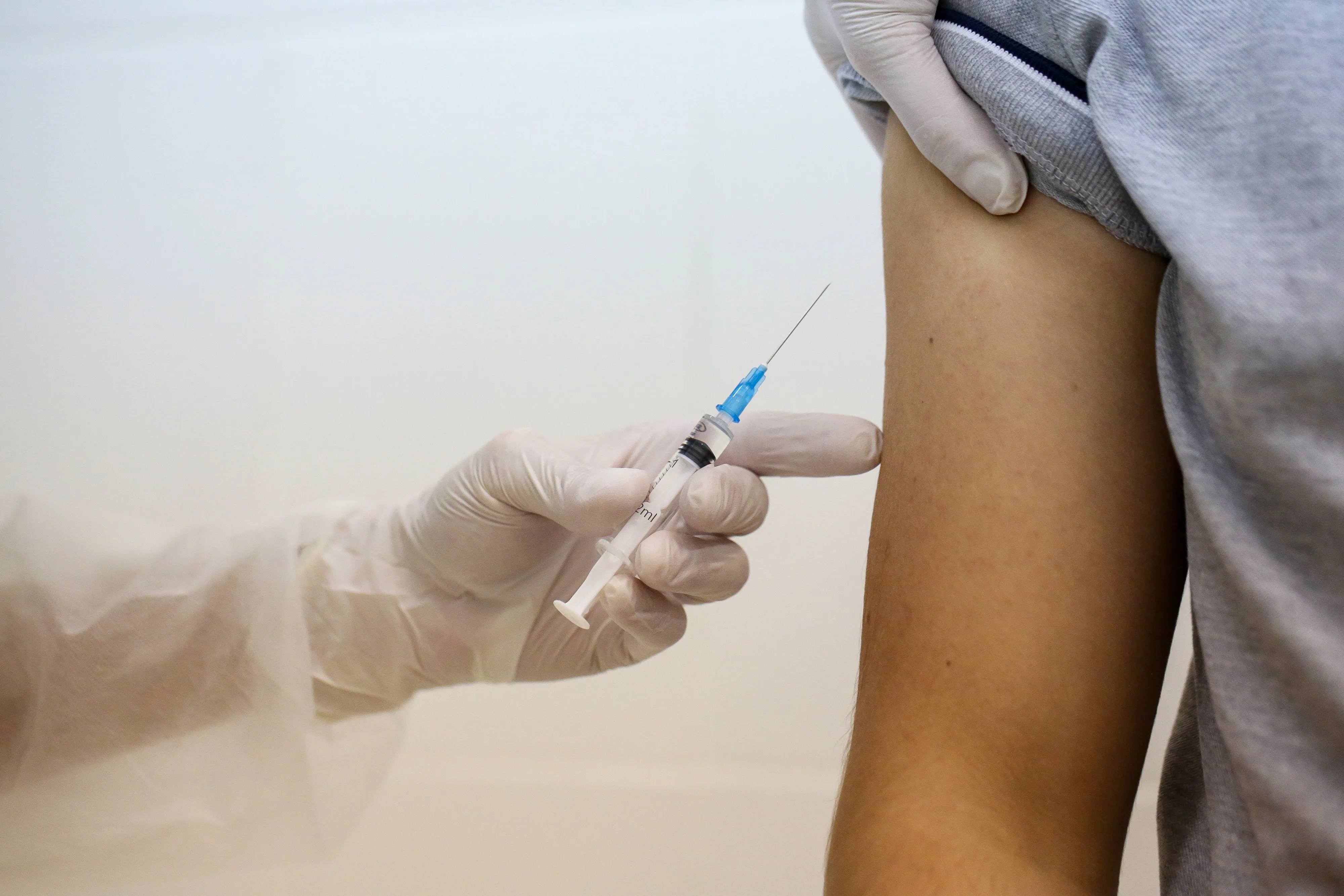 A heath worker prepares to inject the Covid-19 trial vaccine into a patient.
