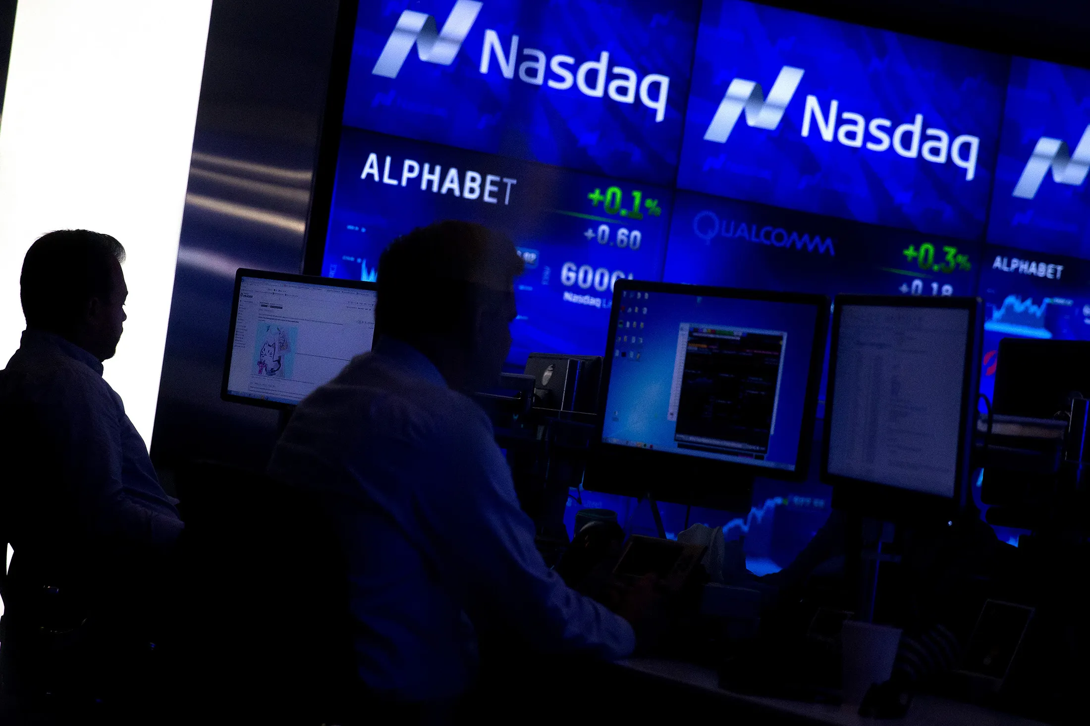 Analysts are seen monitoring data at the Market Intelligence Desk inside the Nasdaq MarketSite in New York.
