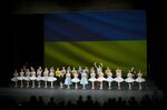 Ukrainian dancers of the Kyiv City Ballet company acknowledge applause in front of Ukrainian flag projected onto a screen at the end of a performance, at the Theatre de Chatelet, in Paris, Tuesday, March 8, 2022. The Kyiv City Ballet danced to a full house in Paris for the last show of a French tour that has left the company stranded after the war broke out in Ukraine. They described being physically and emotionally exhausted. Being given the opportunity to train and dance was for many a chance to focus on something other than the war.  (AP Photo/Thibault Camus)