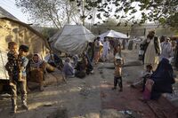 Displaced Afghans arrive at a makeshift camp in Kabul.