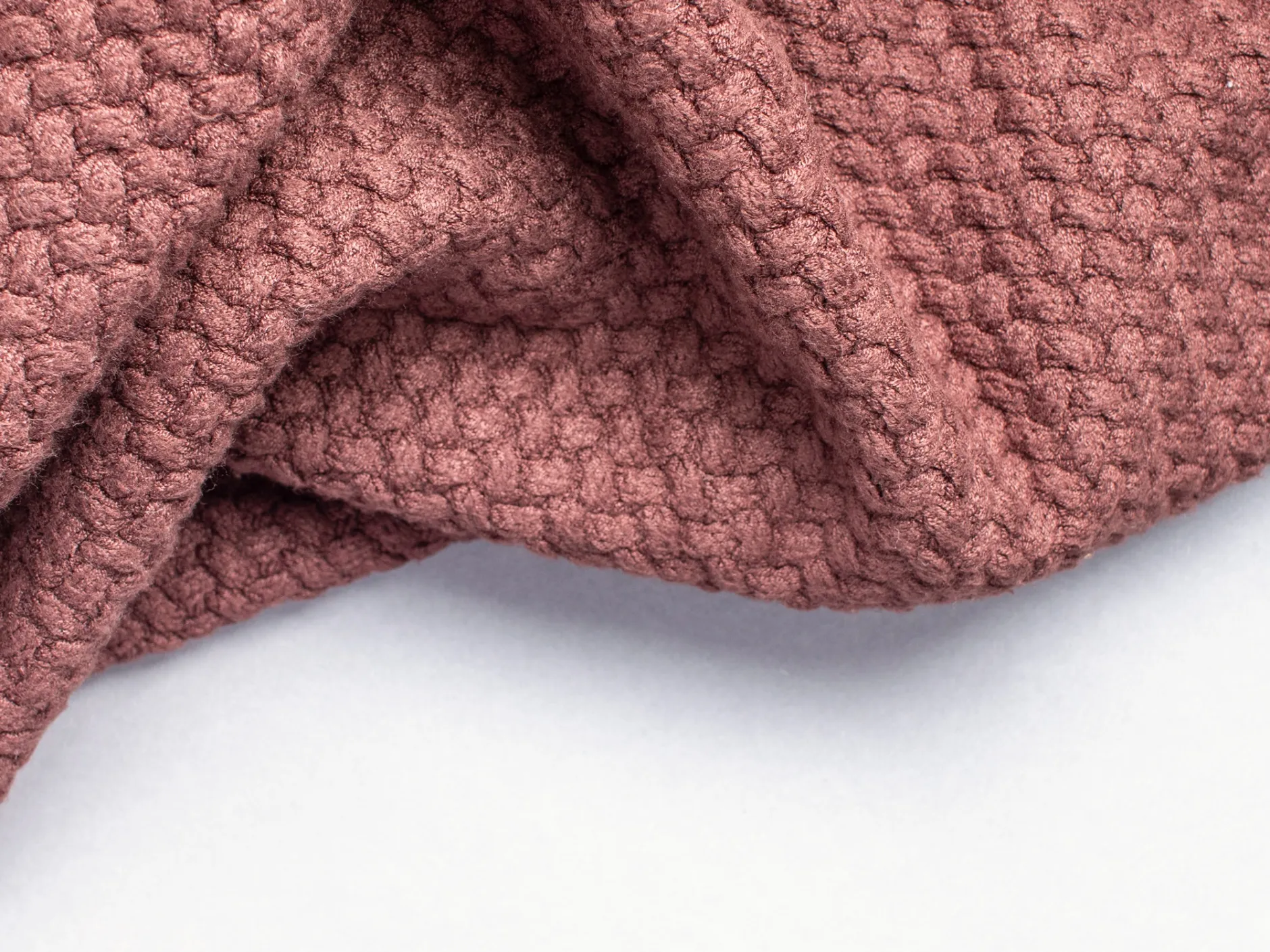 Crumpled brown woolen fabric.