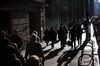 Pedestrians walk along Wall Street near the New York Stock Exchange (NYSE) in New York, U.S.