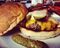 A hamburger with pickles, cheese, bacon and horseradish mayo at MEATS.
