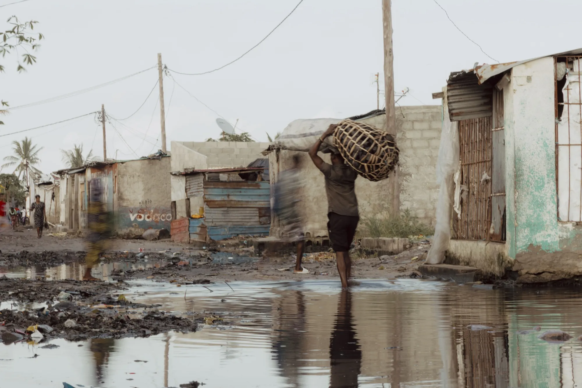 Residents walk along a flooded street in the Praia Nova neighborhood of Beira, Mozambique, on March 20, 2024.&nbsp;