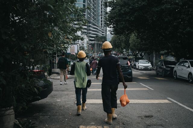Bangladeshi workers leave a construction site in Kuala Lumpur, Malaysia, on May 30, 2025. Photographer: Samsul Said/Bloomberg