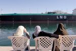 Women observe a Liquefied Natural Gas (LNG) tanker as it sails on the Suez Canal, Egypt. 