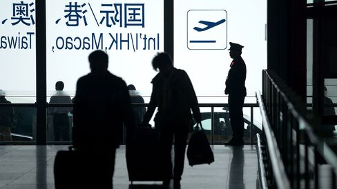A policeman stands guard at the entrance of Beijing's international airport.