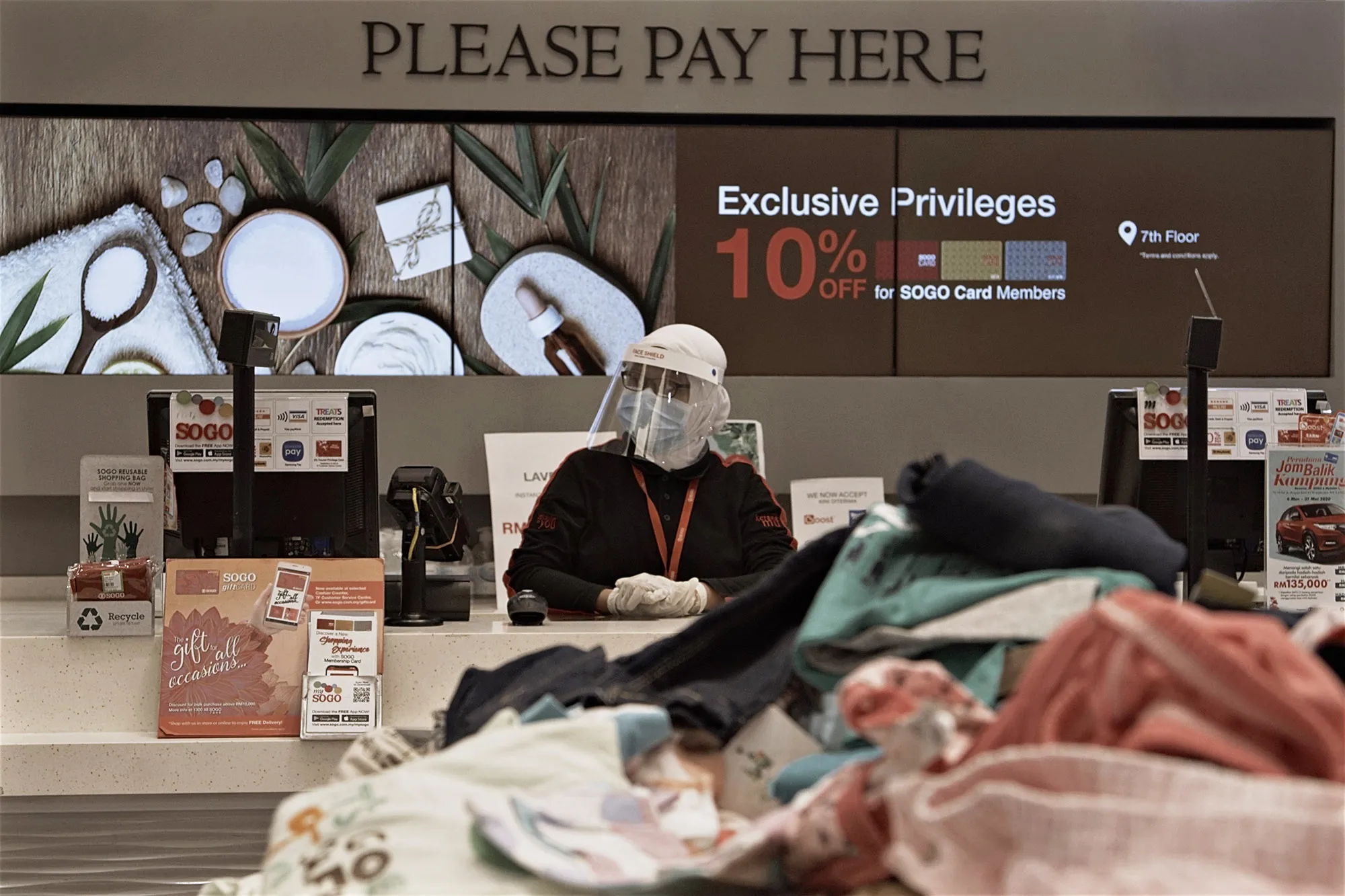 A retail store worker waits for customers in Kuala Lumpur, on May 4.