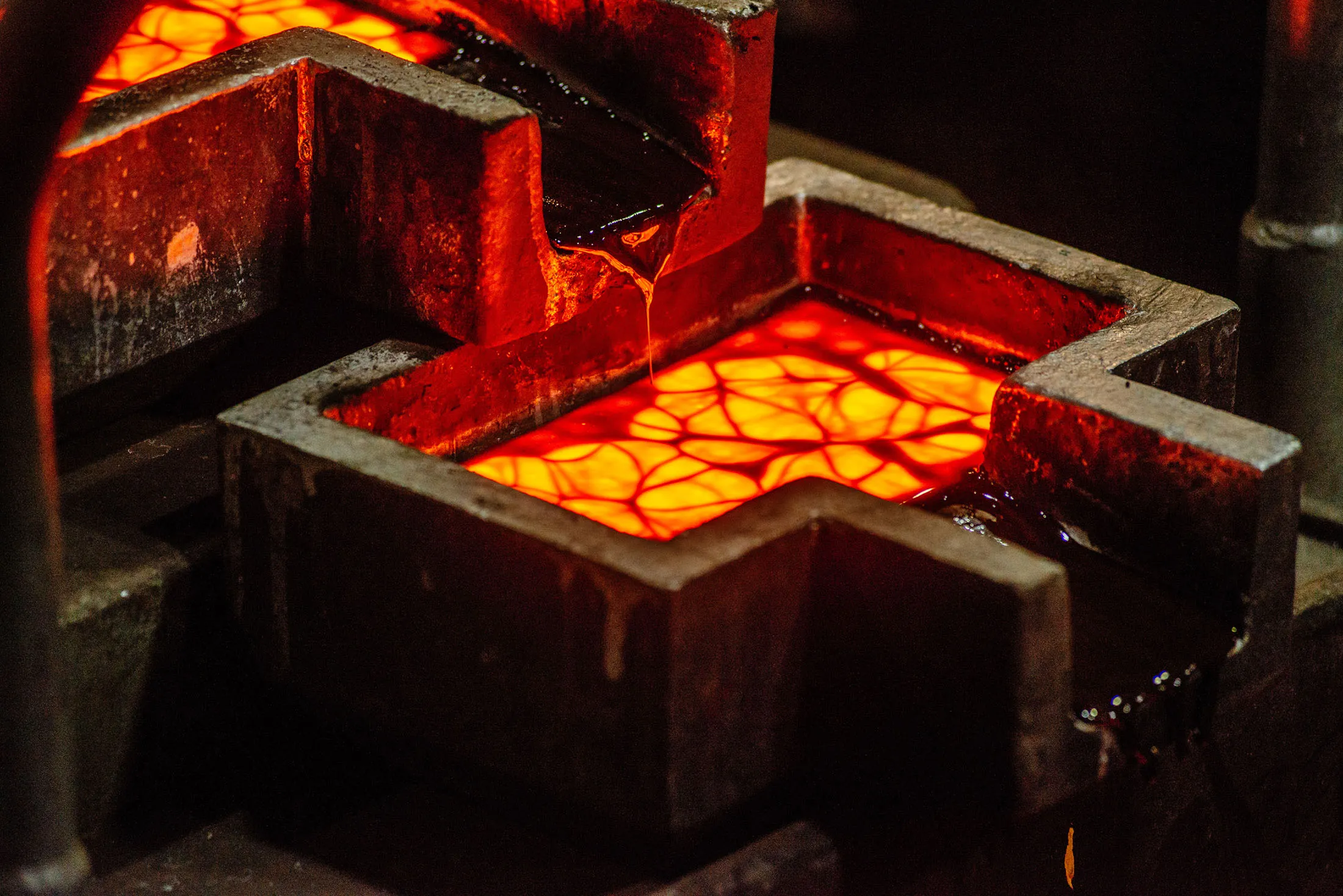 Liquid gold flows from a furnace into a casting mold to create a 28 kilogram gold bar in a foundry in Westonaria, South Africa.