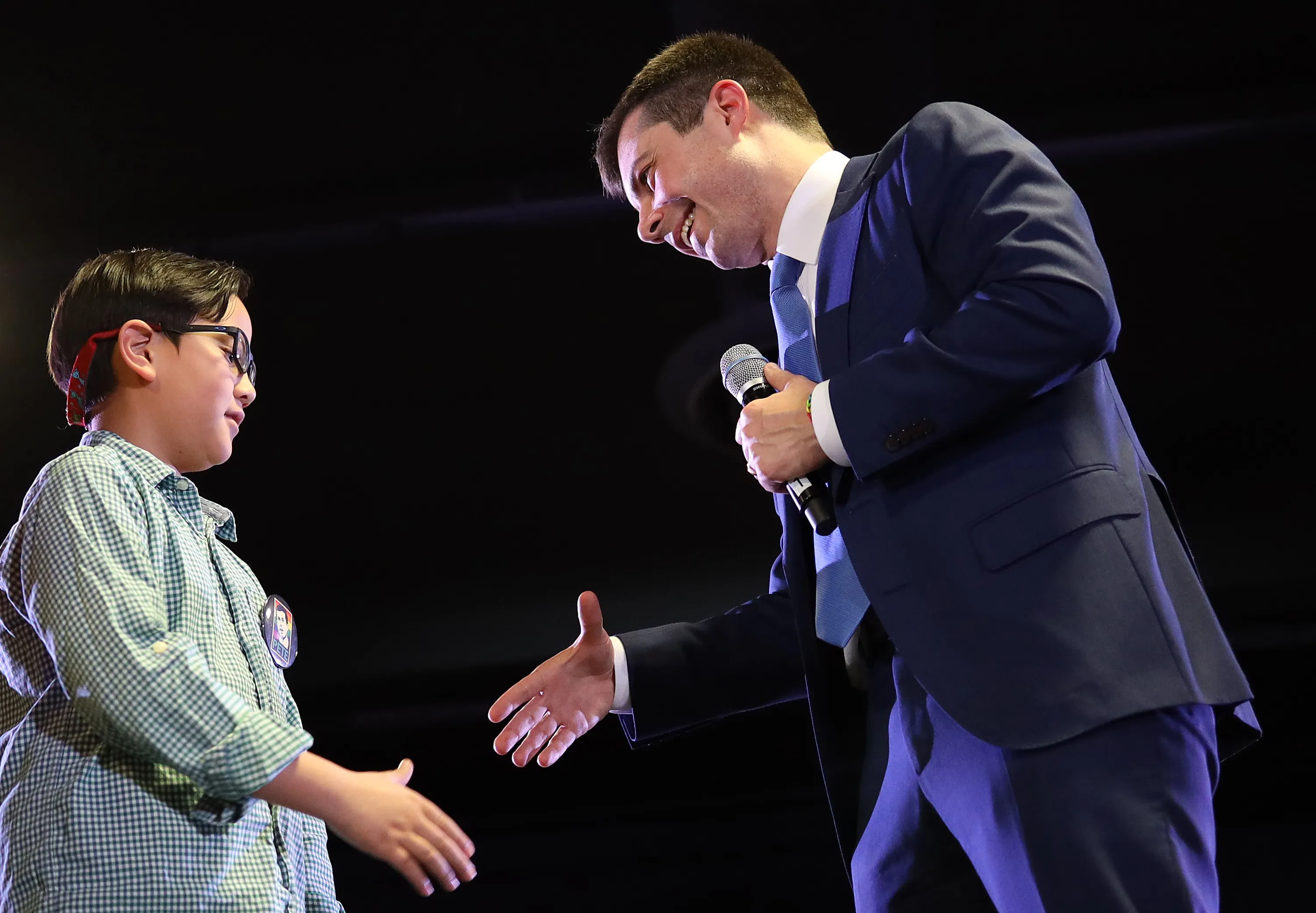 Pete Buttigieg greets Zachary on stage at a campaign event in Denver on Feb. 22.