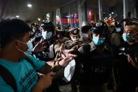 Police face pro-democracy demonstrators during a rally in support of four protest leaders who were denied bail, in Bangkok, on Feb. 9.