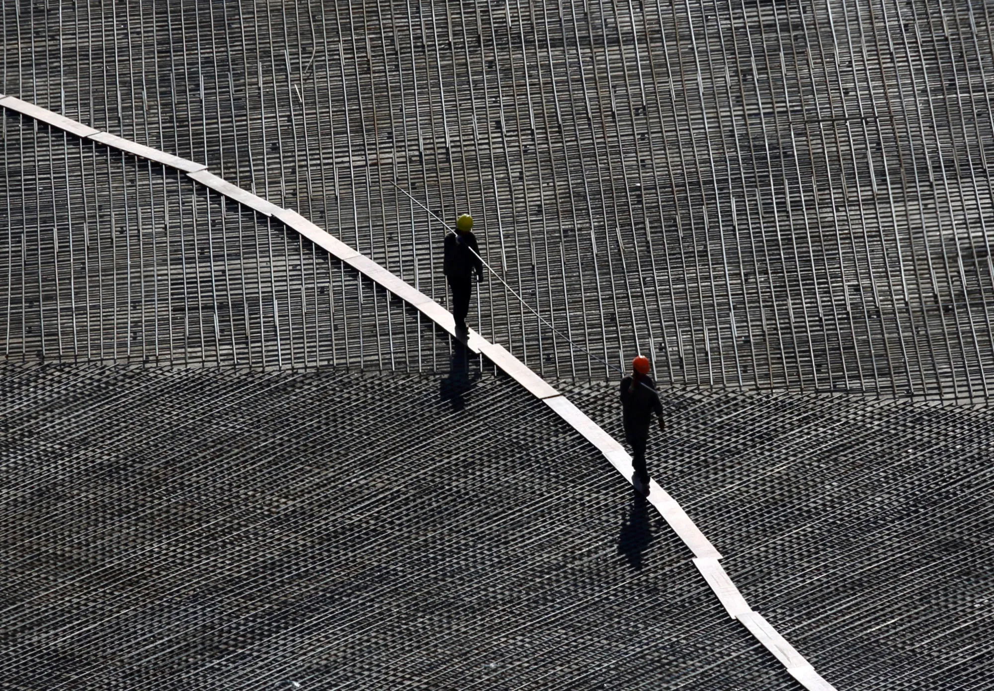 Workers walk across the construction site of a residential building in Ulaanbaatar, Mongoli.
