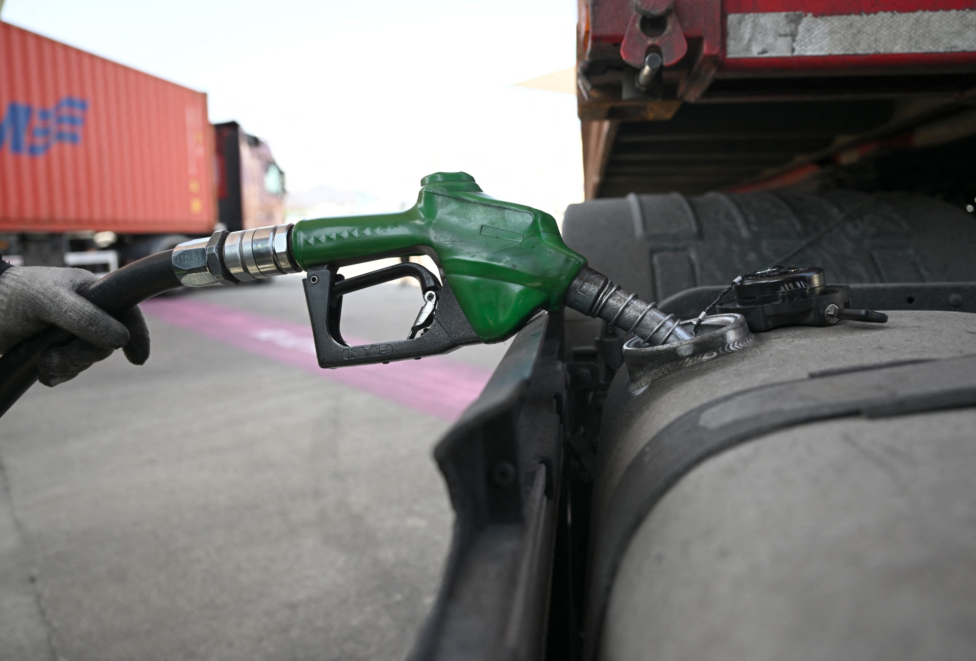 A man fills up a truck at a petrol station of an Inland Container Depot (ICD) terminal in Uiwang on March 13, 2026. Brent crude inched further above 100 USD a barrel and stocks fell in early Asian trade on March 13, after Iran vowed to attack oil resources in the Middle East and keep choking the Strait of Hormuz. (Photo by Jung Yeon-je / AFP via Getty Images) Photographer: JUNG YEON-JE/AFP