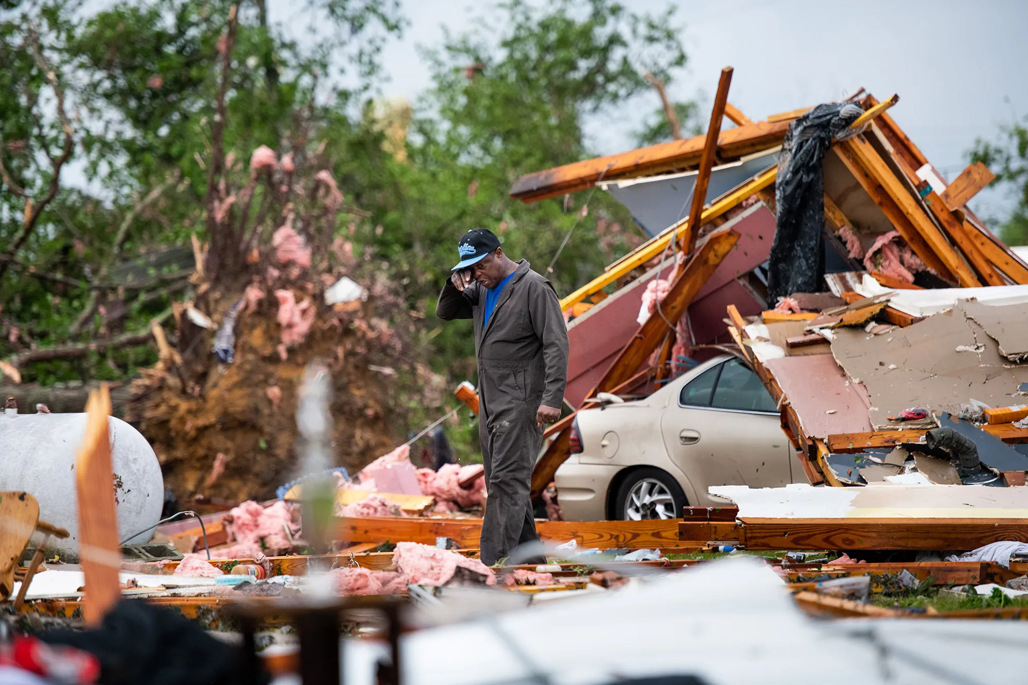 A man looks at the storm damaged home of his sister-in-law in Livingston, South Carolina on April 13.