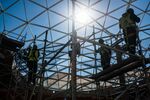 Construction workers stand on scaffolding in Johannesburg.