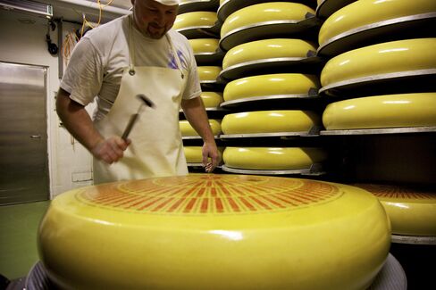 An Employee Tests a Whole Cheese for Holes