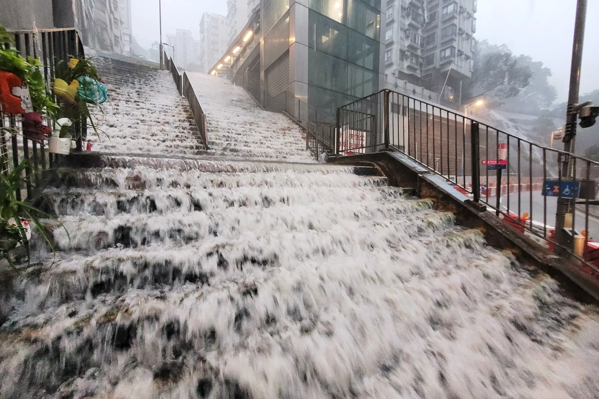 Rainwater descends down a staircase in the Kennedy Town district of Hong Kong on Aug. 14.