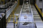 Boxes and parcels move along conveyors in an Amazon.com Inc. fulfilment center.